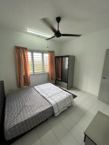 a bedroom with a bed and a ceiling fan at Residensi Idaman Cyberjaya in Cyberjaya