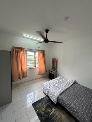 a bedroom with a bed and a ceiling fan at Residensi Idaman Cyberjaya in Cyberjaya