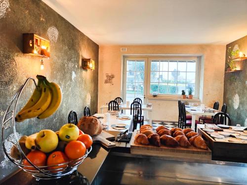a table with a bunch of bread and fruit on it at Albergo B&B Tenesi in Manerba del Garda