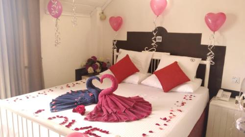 a bedroom with a bed with hearts and balloons at Misty Paradise of Lake Gregory in Nuwara Eliya
