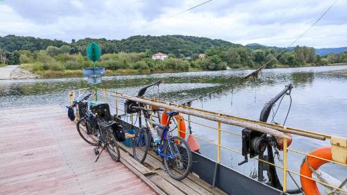 two bikes parked on a dock next to a boat at Viking Rożnów in Rożnów
