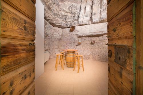 a room with wooden walls and a table and stools at Ca' Del Jago Sole Luna apartment in Negrar