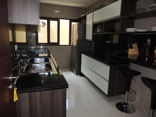 a kitchen with a sink and a counter top at Casa Luxuosa a 50m da Praia em Sirinhaém in Sirinhaém