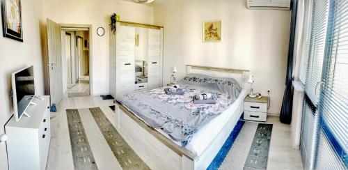 a bedroom with a bed in a room at Venum in Varna City
