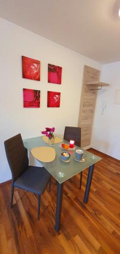 a table with two chairs and a table with flowers on it at Boutique-Hotel Kronenstuben in Ludwigsburg