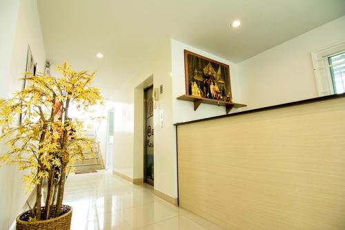 a hallway of a home with a large wooden wall at At Ease Hotel Suvarnabhumi in Bang Phli