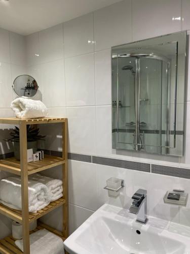 a bathroom with a sink and a mirror at Caemorgan Mansion in Cardigan