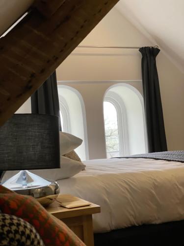 a bedroom with a bed and a window at Caemorgan Mansion in Cardigan