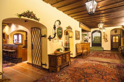 a large living room with an archway and a kitchen at Hotel St. Georg in Zell am See