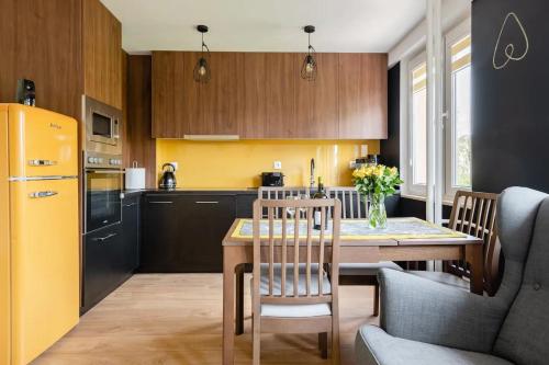 a kitchen with a table and a yellow refrigerator at The Best Location in Cracow for City Break in Kraków