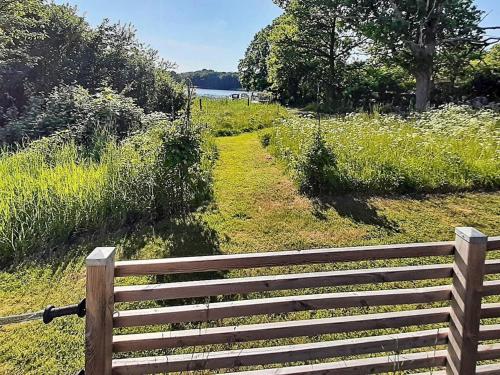 a wooden fence in the middle of a field at 4 person holiday home in TRENSUM-By Traum in Trensum