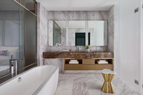 a bathroom with a tub and a sink and a mirror at The Ritz-Carlton, Baku in Baku