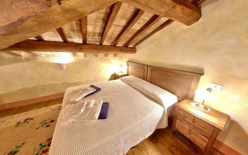 a bedroom with a bed and a wooden ceiling at Monastero Le Grazie in Amelia