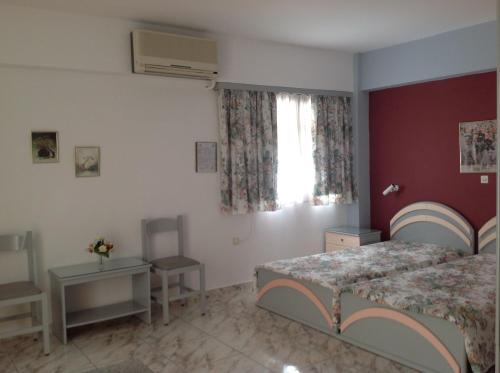 a bedroom with two beds and a window at Travlos Studios in Póros Kefalonias