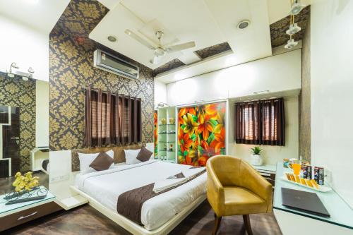 a bedroom with a bed and a desk and a chair at Coliwo Deux - Chandan Nagar in Pune