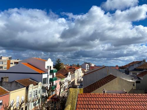 a view of a city under a cloudy sky at Casa da Fonte - Vintage House and Rooftop in Figueira da Foz