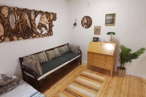 a living room with a couch and a table at Villa Mäntysaari luonnonrauhaa kaupungin lähellä. in Kontiolahti