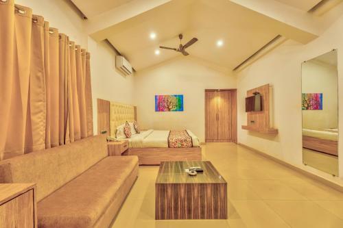 a living room with a couch and a bed at The Boho, Vagator Beach Goa Near Thalassa in Anjuna