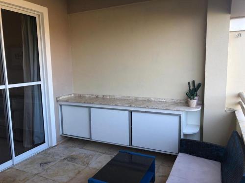 a room with a counter with a toilet and a window at Cumbuco Residence - Beach in Cumbuco
