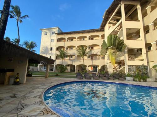 a swimming pool in front of a building at Cumbuco Residence - Beach in Cumbuco