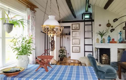 a dining room with a table with a blue table cloth at Beautiful Home In Genvalla With 1 Bedrooms 