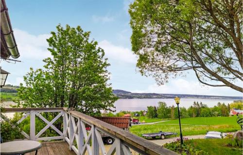 a wooden bridge with a view of a lake at Beautiful Home In Genvalla With 1 Bedrooms 