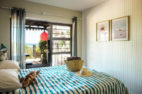 a bedroom with a bed with a view of the ocean at Paradise Self-Catering Units in Jeffreys Bay
