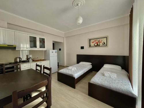 a kitchen with two beds and a table in a room at Summer Dreams in Ksamil
