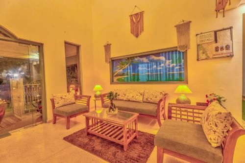a living room with couches and a coffee table at The Boho, Vagator Beach Goa Near Thalassa in Anjuna
