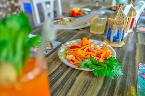 a plate of vegetables on a wooden table at The Boho, Vagator Beach Goa Near Thalassa in Anjuna