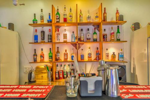 a bar with shelves filled with bottles of alcohol at The Boho, Vagator Beach Goa Near Thalassa in Anjuna