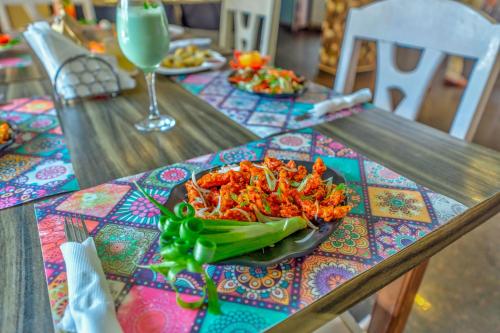 a plate of food on top of a table at The Boho, Vagator Beach Goa Near Thalassa in Anjuna