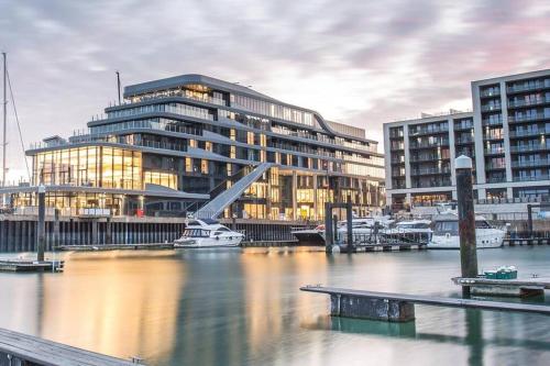 a large building next to a body of water with boats at Apartment in St Denys in Southampton