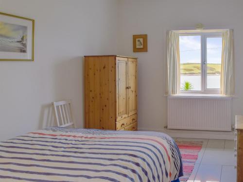 a bedroom with a bed and a window at Cliff Cottage - Uk43207 in Dale