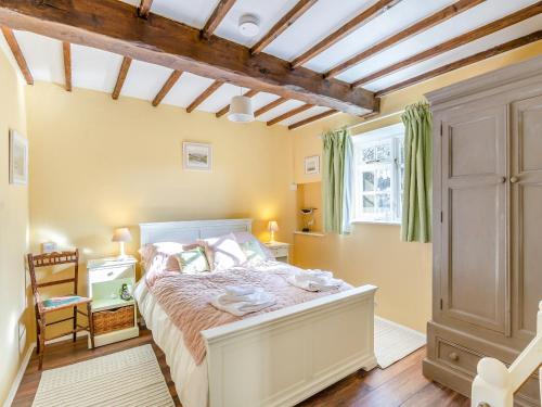 a bedroom with a bed and a window at The Barn in Ropsley