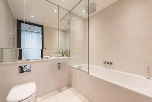 a bathroom with a toilet and a sink and a shower at New Build-Air Con-2 Bedroom-Two Bathrooms Apt 3 in London