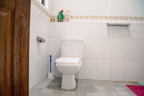 a bathroom with a white toilet in a room at The Fancy Luxurious 3 bedroom apartment in Nakuru