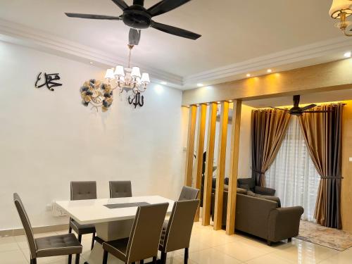 a dining room with a white table and chairs at Sofiamuslim Homestay Putrajaya in Putrajaya