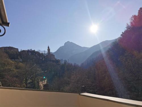 a view of a mountain valley with the sun shining at Agriturismo Dai Marchesin in Nasino
