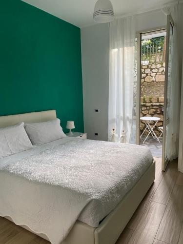 una camera da letto con un letto grande con una parete verde di Enjoy Home Sorrento a Sorrento