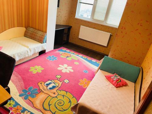 a small room with a bed and a rug at Svetlana Apartment in Chişinău