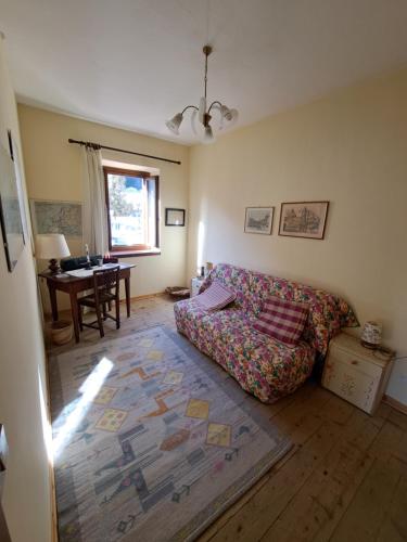 a living room with a couch and a table at L' antica Casa di Maria Lilia in Pieve di Cadore