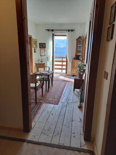 an open door to a living room with a table and chairs at L' antica Casa di Maria Lilia in Pieve di Cadore
