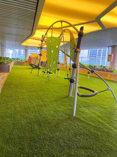 a playground with a slide in a room with grass at Air Residences-Stylish&Comfort Stay High flat with balcony in Manila