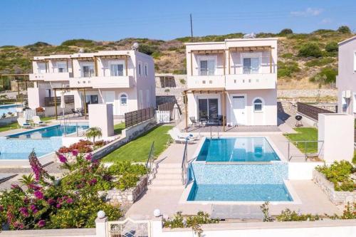 an aerial view of a house with two swimming pools at Villa Regina - Double Pool Paradise in Lachania