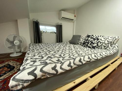 a large bed in a bedroom with a bed frame at Sweet Loft Homestay in Johor Bahru