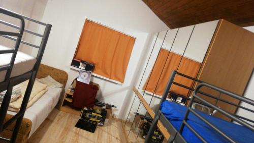 a small room with two bunk beds and a bed at GALATA house along the river Danube in Radvaň nad Dunajom