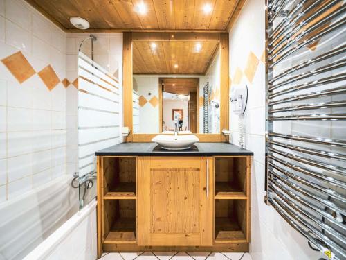 a bathroom with a sink and a mirror at Appartement Tignes, 3 pièces, 6 personnes - FR-1-502-374 in Tignes