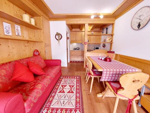 a living room with a red couch and a table at Apartment MEISE in Bad Kleinkirchheim