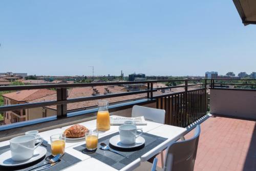 a table with food and drinks on a balcony at Italianflat - Via Adami, 3 Bedroom Flat, FREE PARKING in Verona
